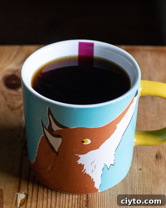 cute fox cup full of fresh black coffee