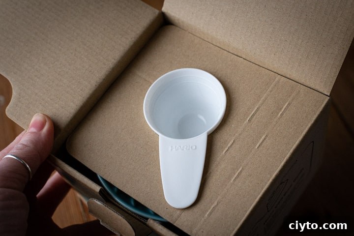 white coffee scoop within the cardboard packaging of the hario v60 box
