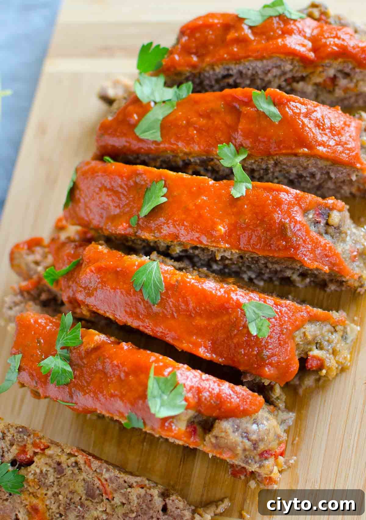 sliced italian meatloaf on cutting board
