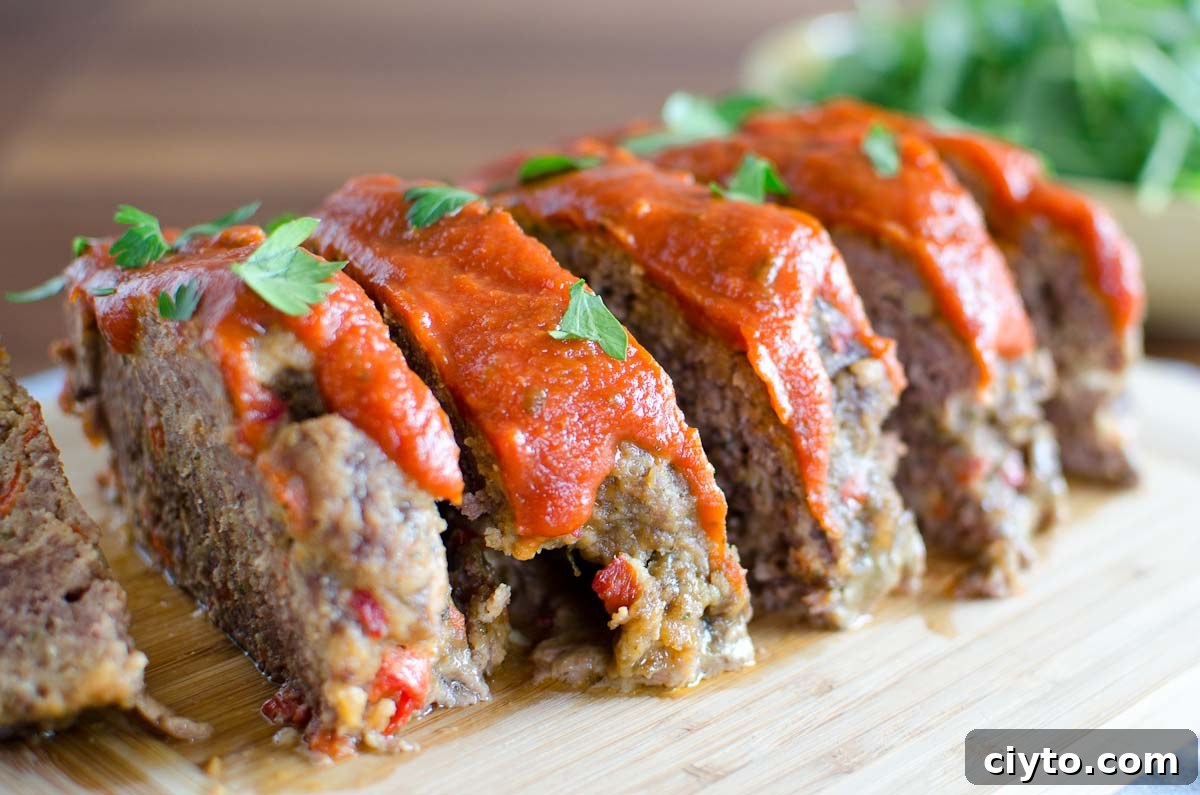 sliced italian meatloaf on cutting board