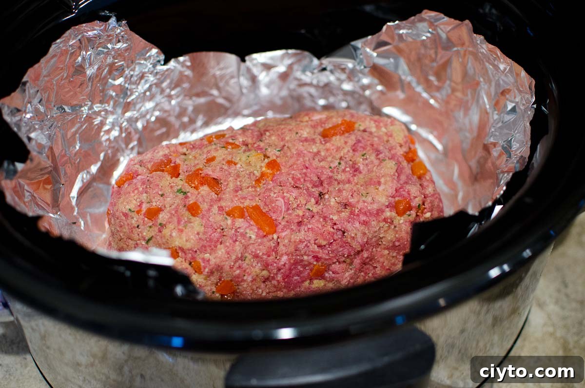 raw meatloaf in crock pot lined with foil