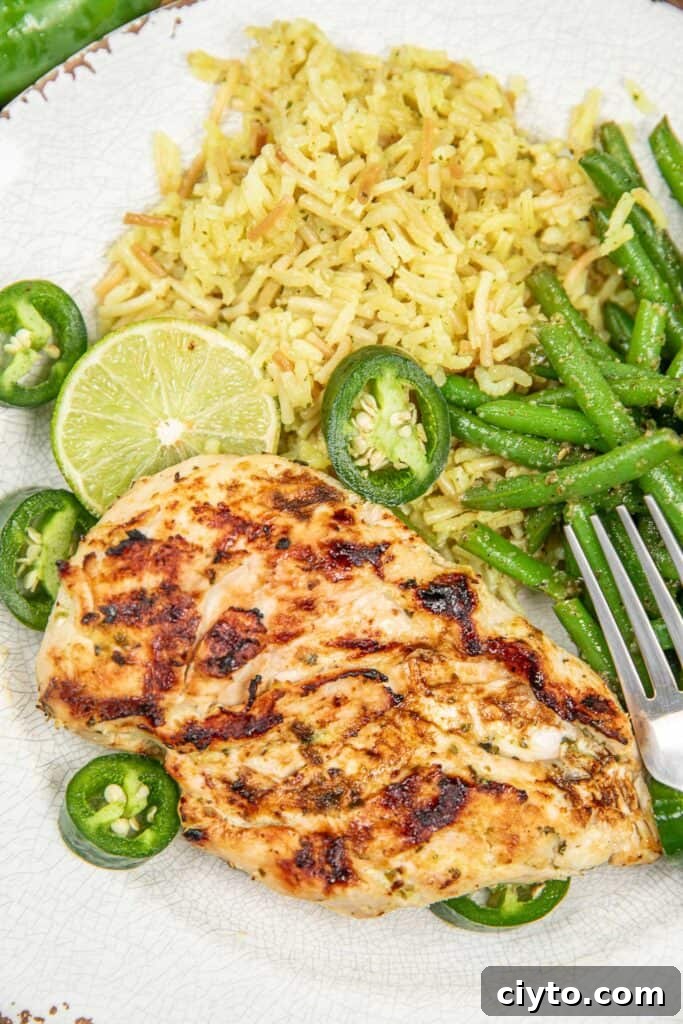 plate of grilled chicken with rice and green beans