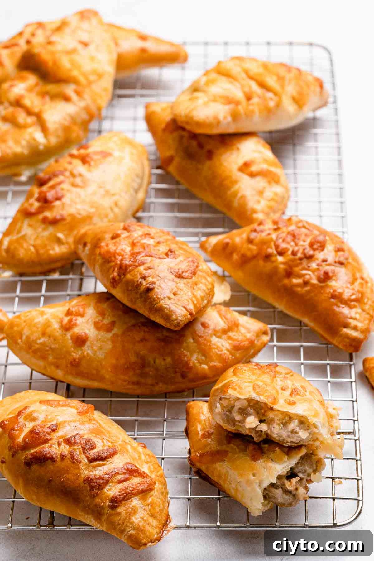 sausage and cheese turnovers on wire cooling rack