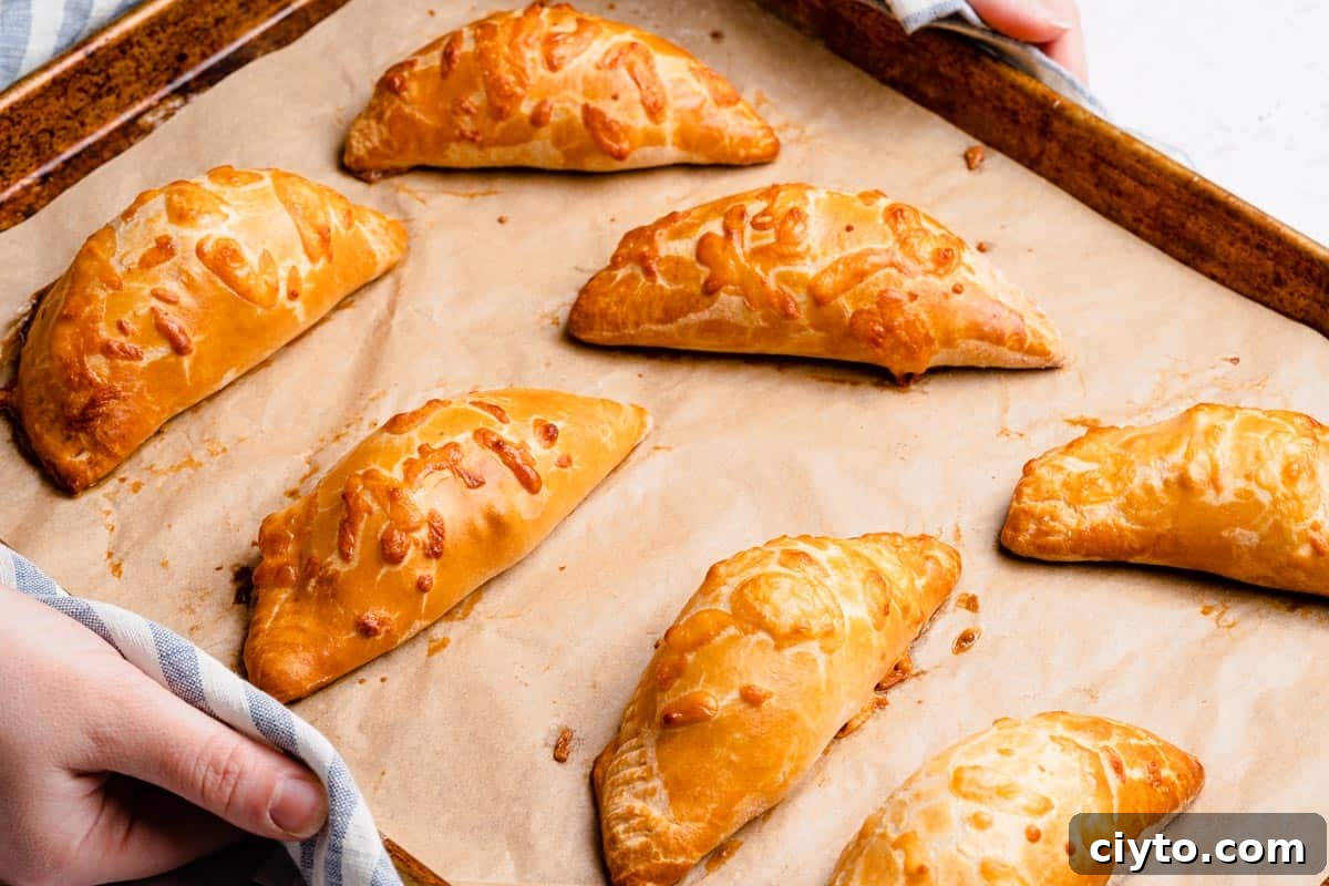 baked turnovers on baking sheet lined with parchment paper