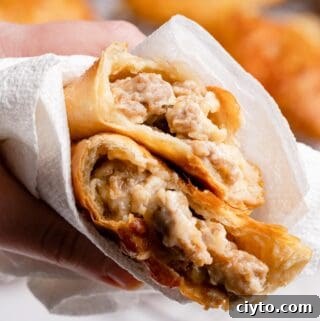 sausage and cheese turnover torn in half wrapped in paper towel