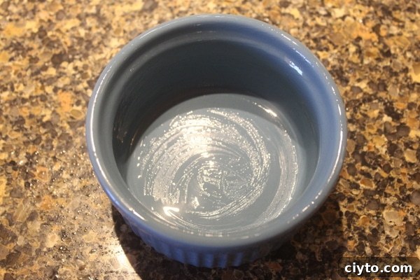 Oiling a ramekin for baking the cookie