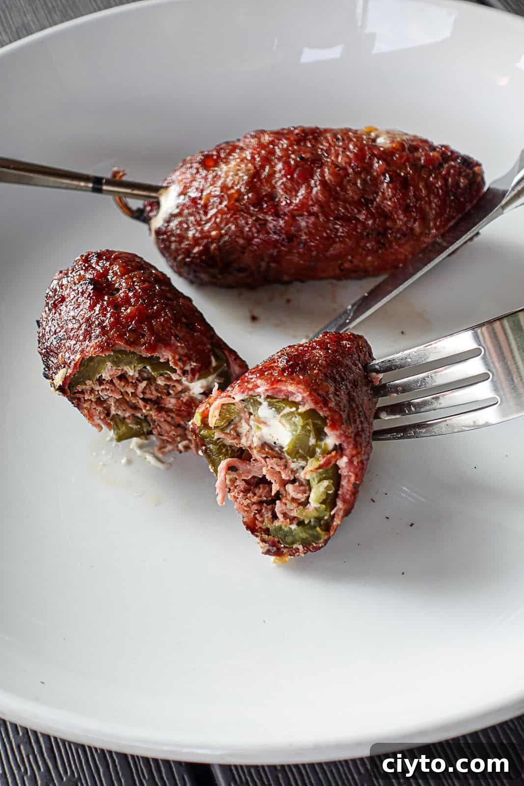 Traeger Smoked Texas Torpedoes inside stuffed with cream cheese jalapeno and Brisket SipBiteGo