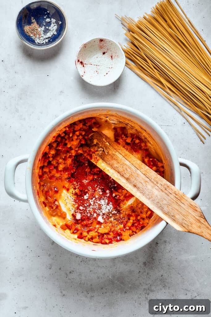 A wooden spoon stirs cooking vegetables in the soup pot.