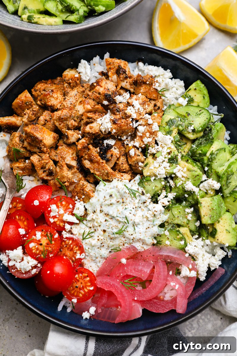 Tzatziki chicken bowls made with diced marinated chicken thighs, cucumber-avocado salad, pickled onions, tomatoes and homemade tzatziki