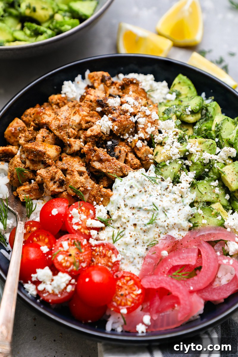 A close up photo of spiced and marinated chicken thighs chopped up and used in a tzatziki chicken bowl