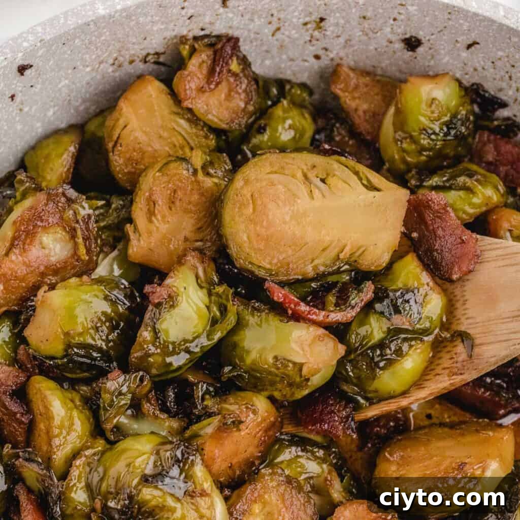 close up of brown sugar bacon brussels sprouts and wooden spoon