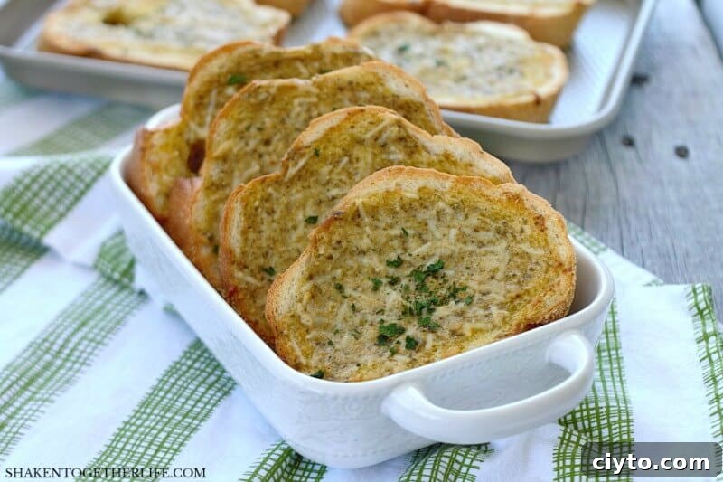Homemade Pesto Parmesan Garlic Bread in white serving dish