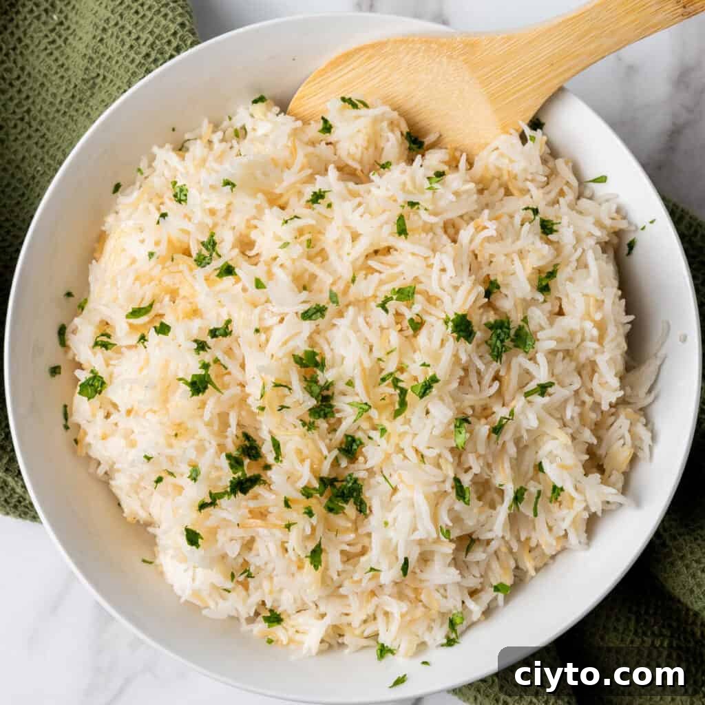 garlic rice in white bowl with wooden spoon