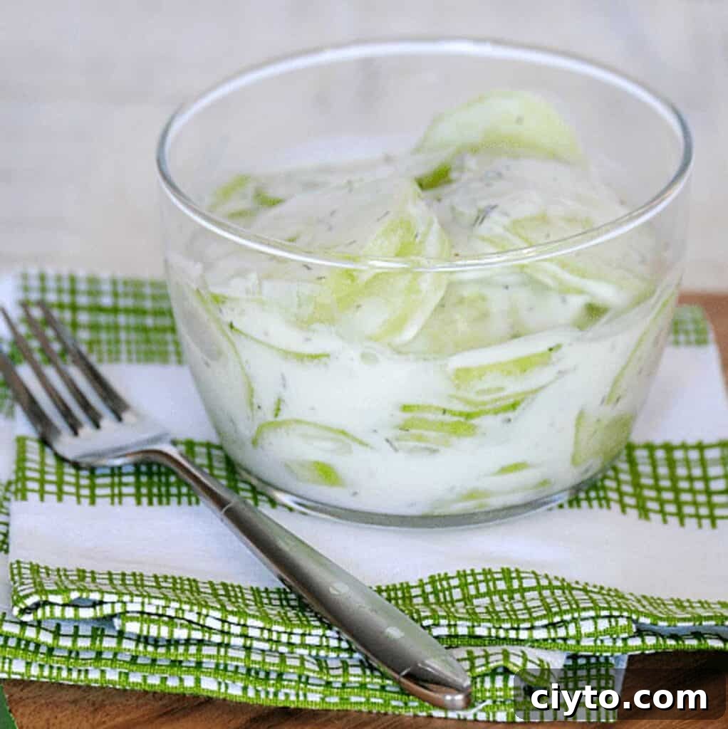 cucumber salad with creamy dressing in glass bowl
