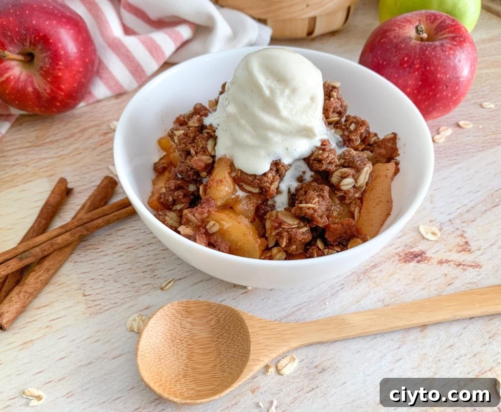 A bowl of Warm Fall Apple Crisp with a sweet, buttery, cinnamon oat crumble topping