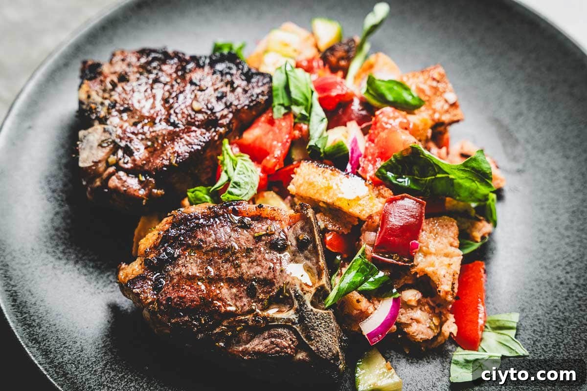 grilled lamb loin chops and panzanella salad on a plate