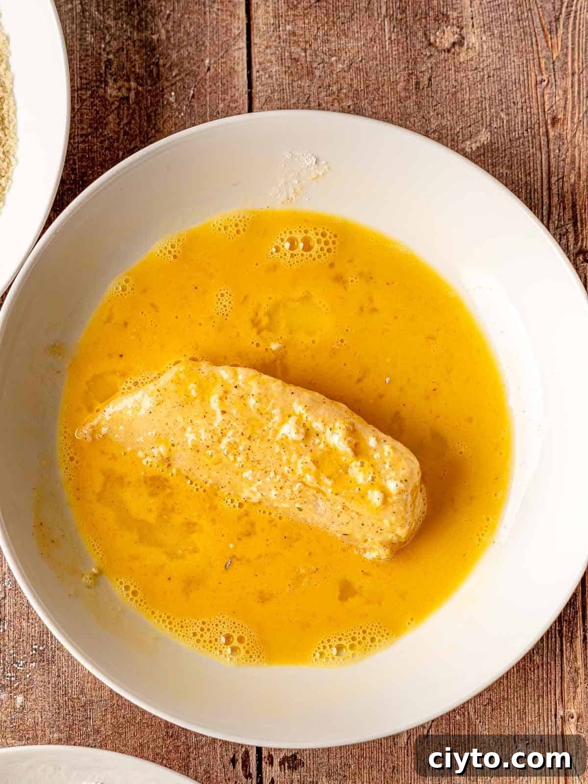 Fish in an egg wash.