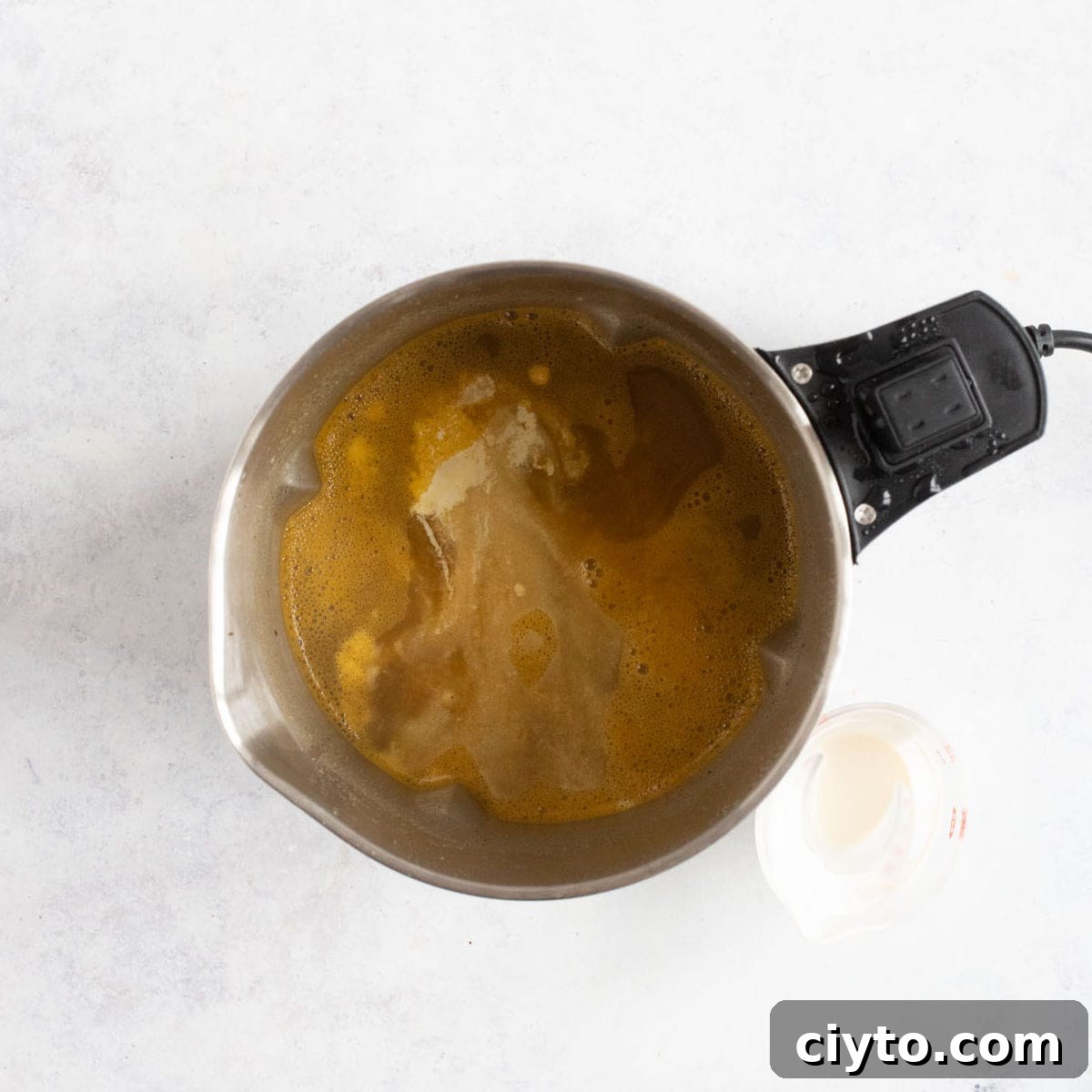 A swirl of double cream into chicken soup in the soup maker.