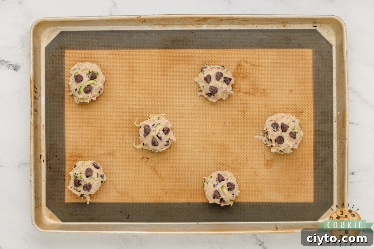 Chewy Zucchini Chocolate Chip Cookie Recipe 6 Scoops of cookie dough on cookie sheet.