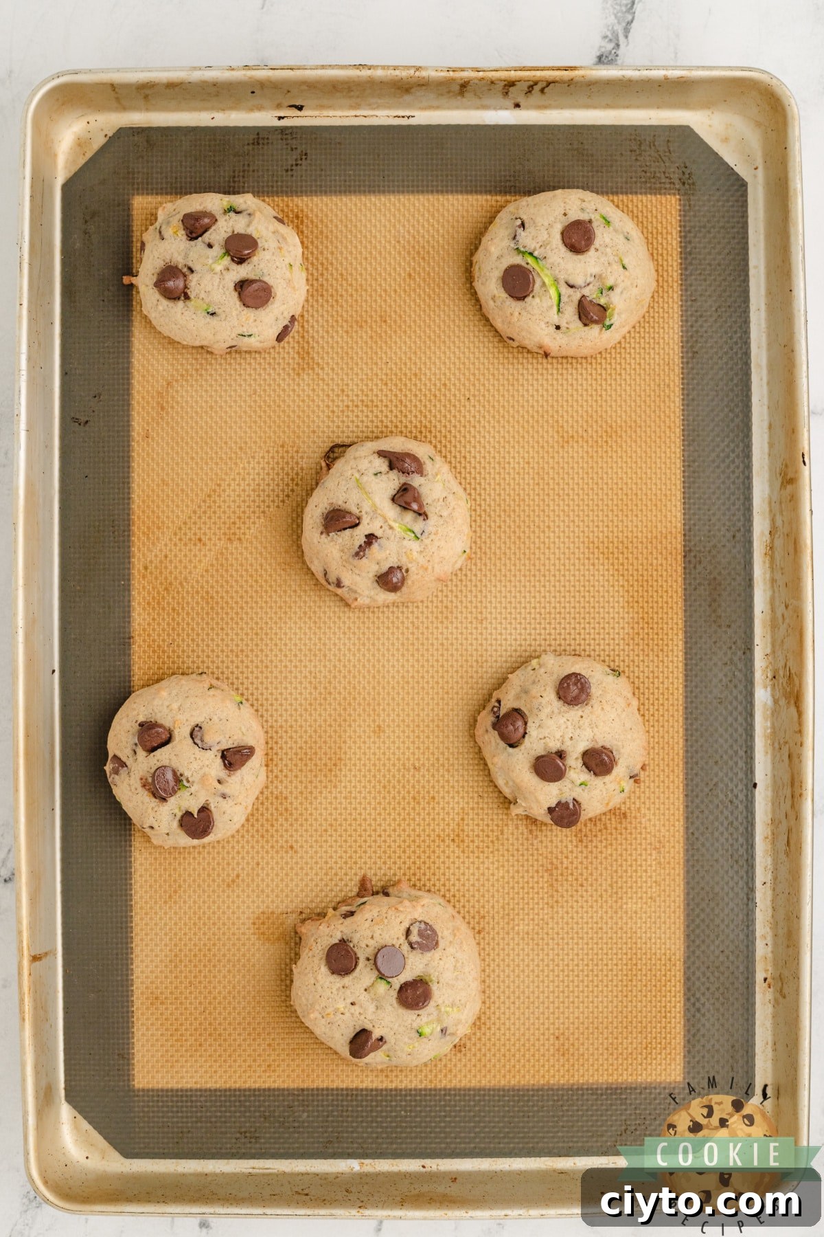 Chewy Zucchini Chocolate Chip Cookie Recipe 7 Baked cookies on cookie sheet.