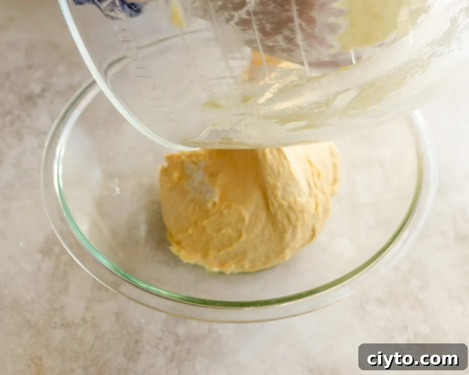 Transfer dough to the greased bowl.