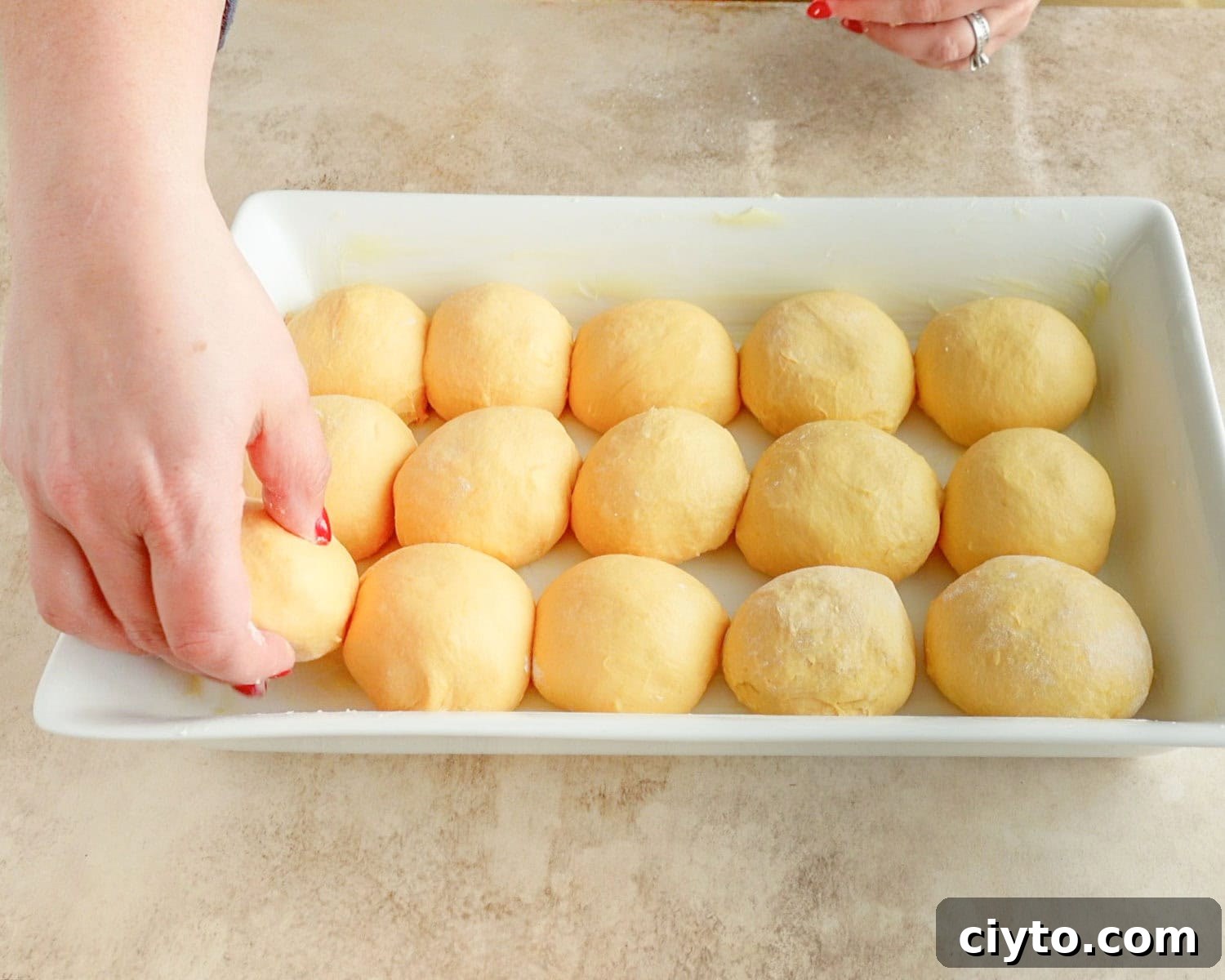 Place dough balls into greased baking dish.