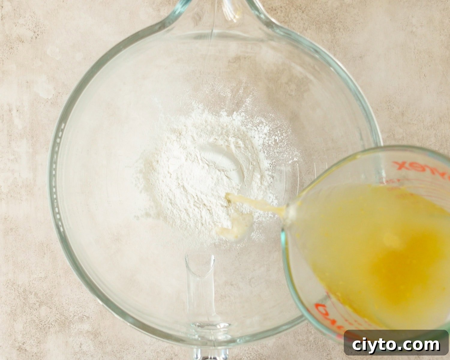 Add reserved cooking water to flour in the bowl of a stand mixer.
