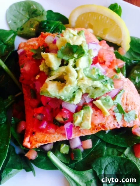 Grilled Southwest Salmon Salad with Avocado, Corn, and Lime 2 Southwest Salmon over spinach topped with diced ed onion, fresh salsa, cilantro, and avocado with a lemon wedge on the side