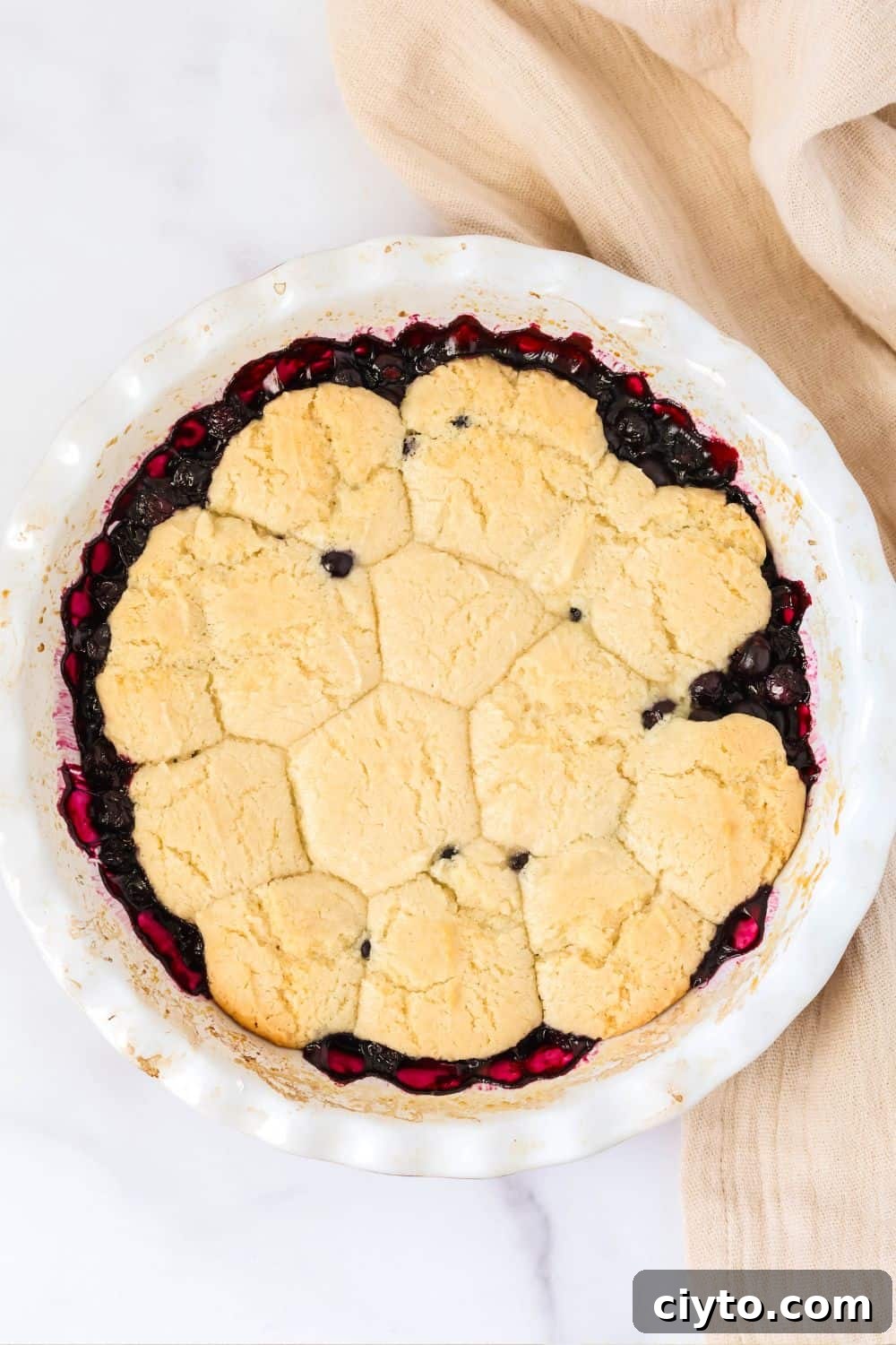 Quick Bisquick Blueberry Cobbler Recipe for Summer 3 overhead view of southern blueberry sonker cobbler in a white pie plate.