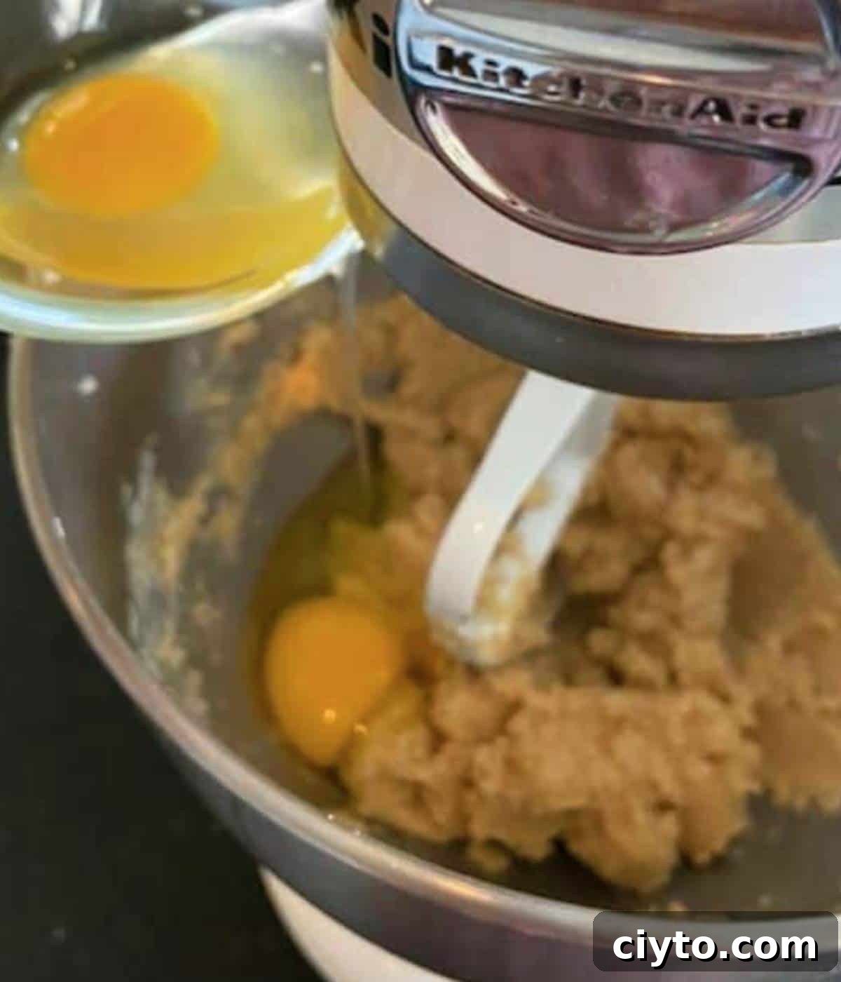 Moist Pumpkin Bread with Cream Cheese Frosting 7 Adding eggs into mixer.