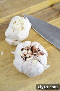 Slicing the top off garlic for smoked garlic