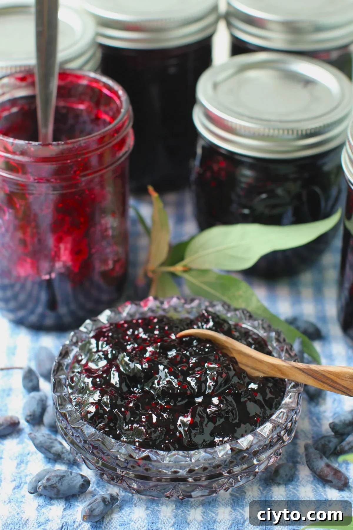 cut glass bowl of haskap jam in front of jam jar