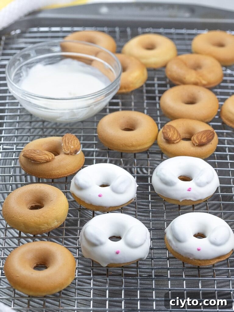 Easter bunny donuts with white candy melt on top of a cooling rack