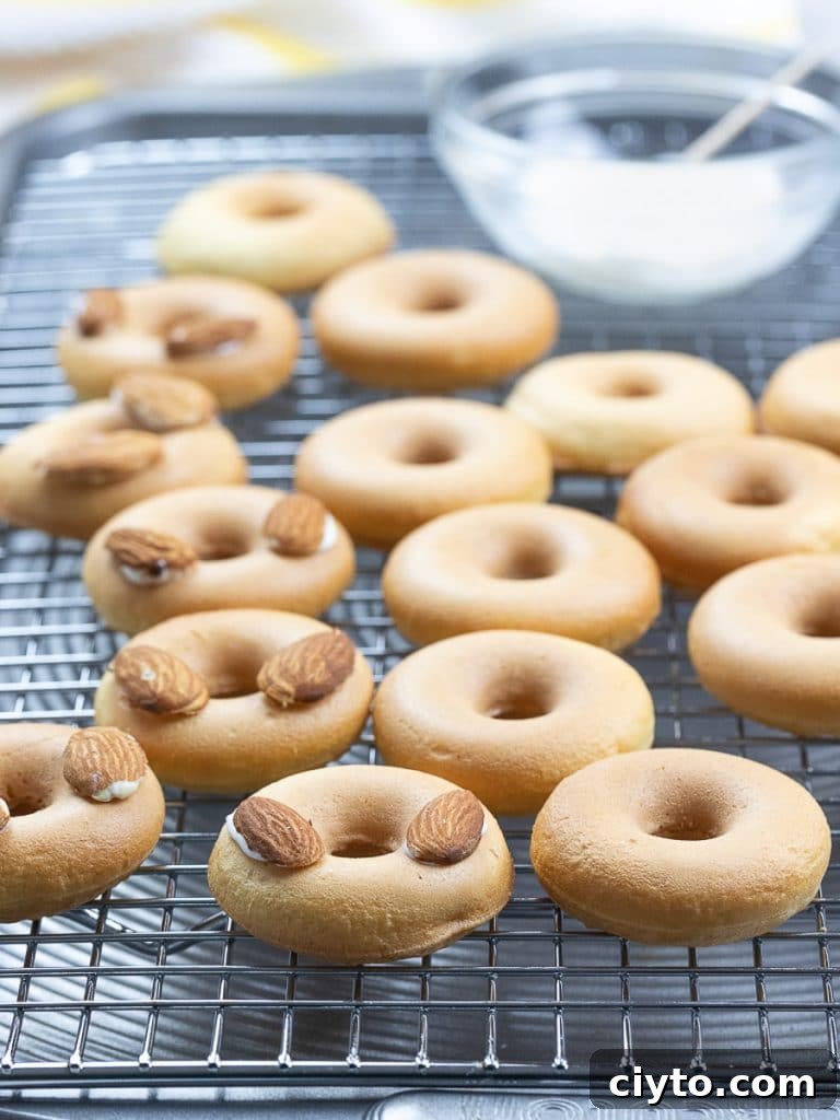 Easter bunny donuts with almond ears on a cooling rack