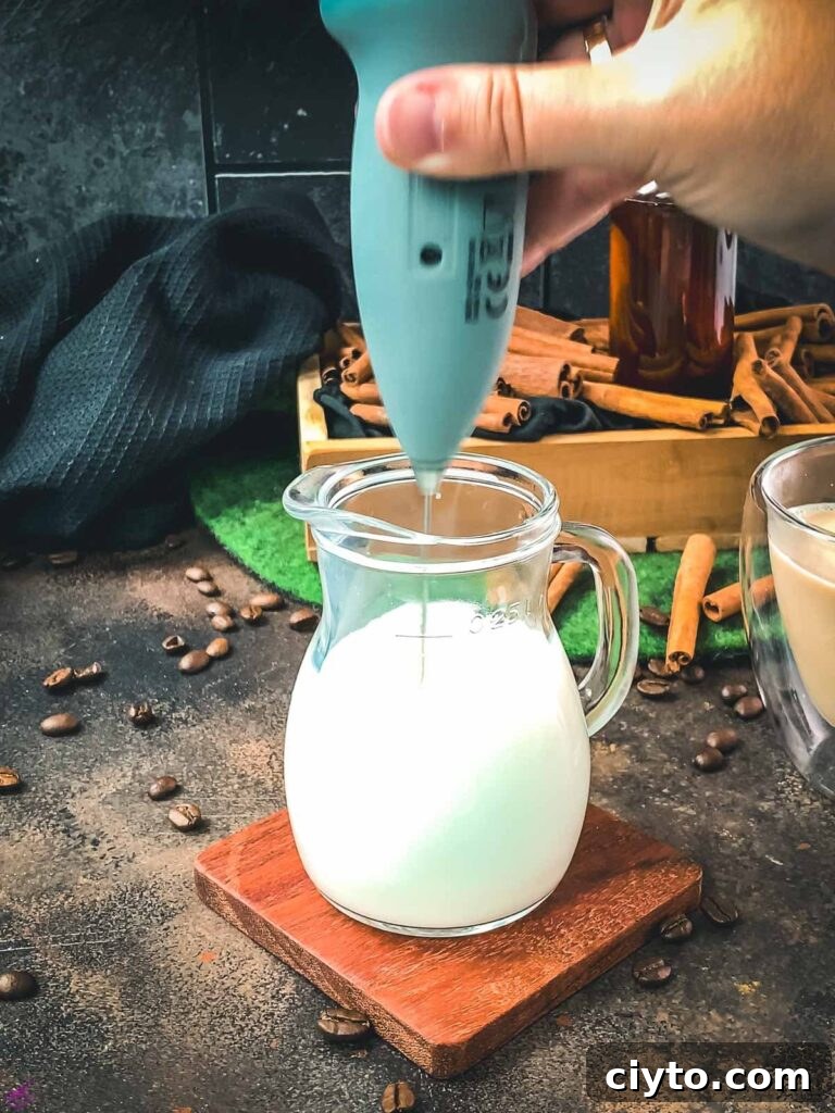Froth the milk with a handheld milk frother.