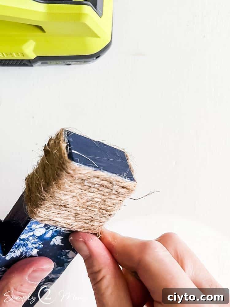 AnnMarie decorating paper mache number with twine for graduation decor
