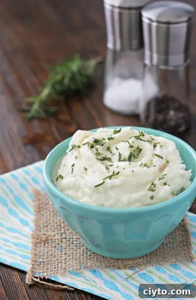 A bowl filled with Mashed Cauliflower with Cream Cheese.