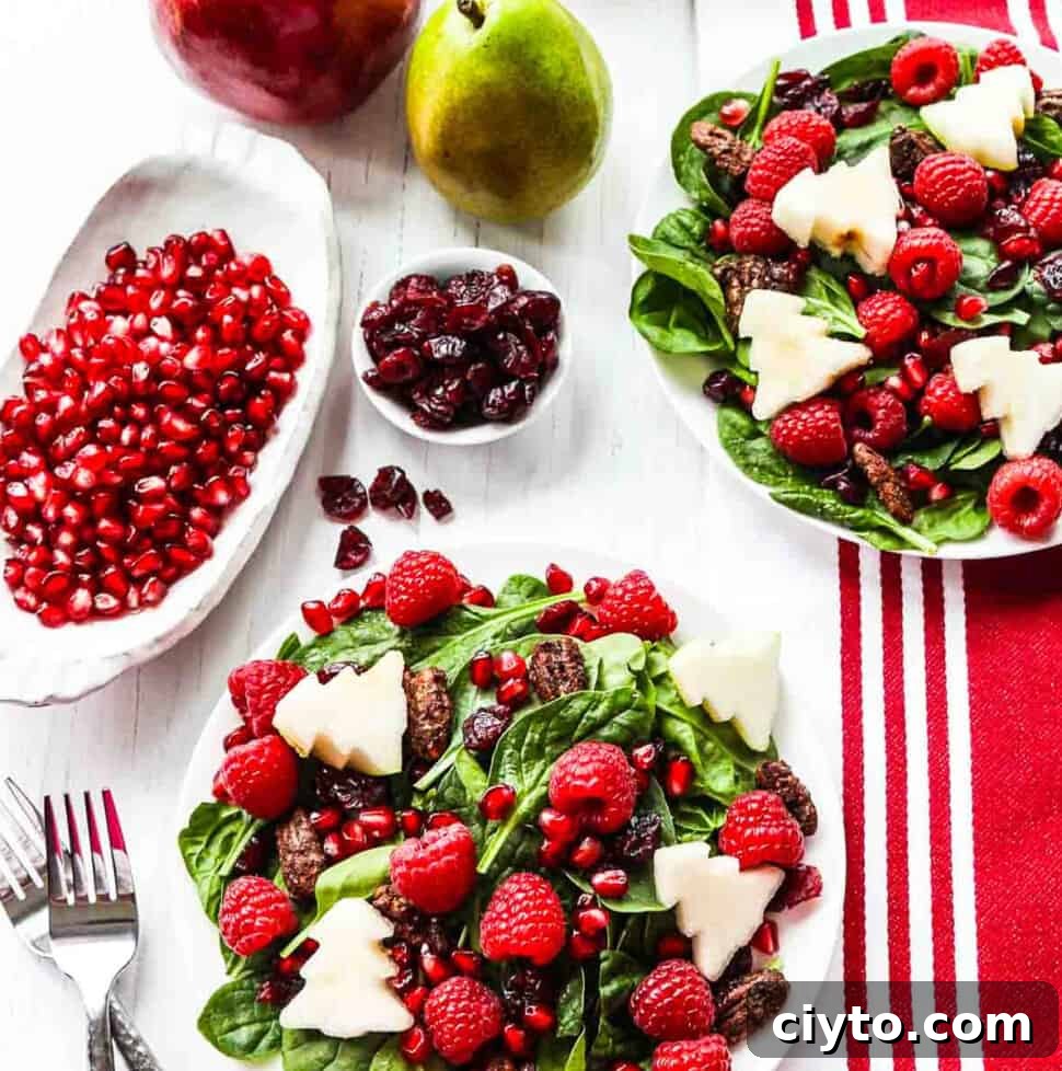Two plates of Christmas salad with forks
