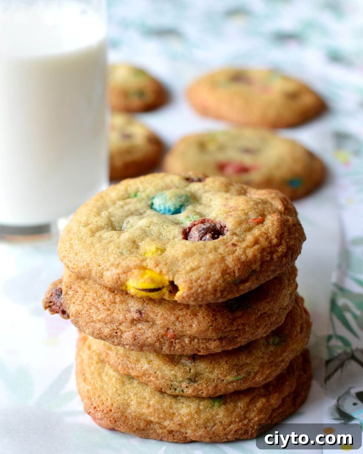 A close up of a stack of m&m cookies.