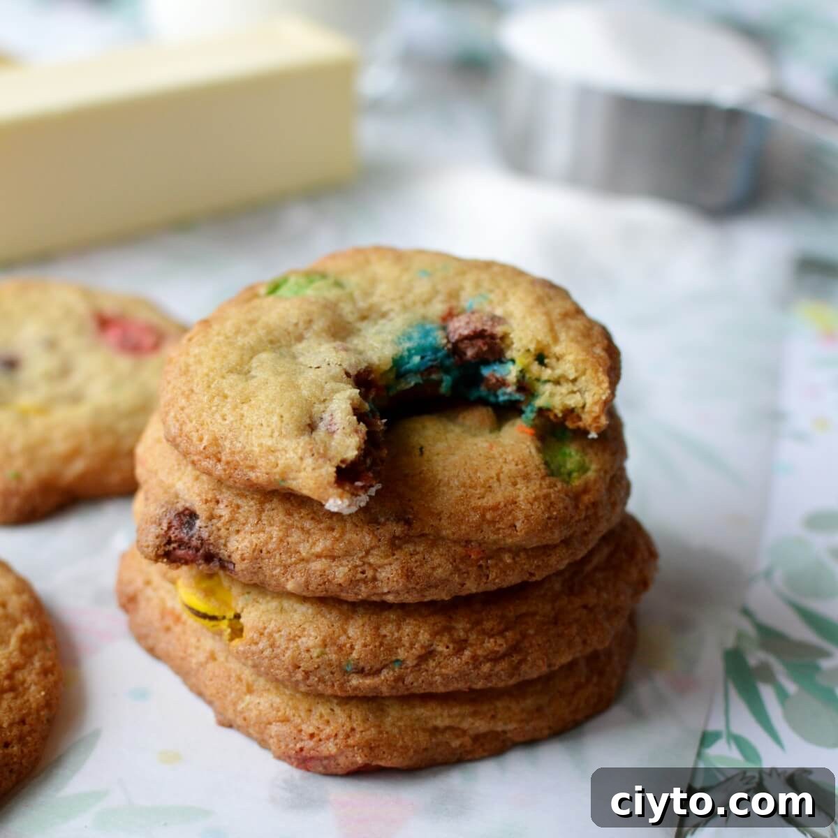 A stack of gluten free cookies with a bite out of the top cookie. 