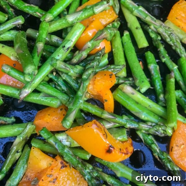 Why People Eat Too Few Vegetables and How to Eat More 4 asparagus pieces and orange sweet pepper pieces in grilling basket on bbq