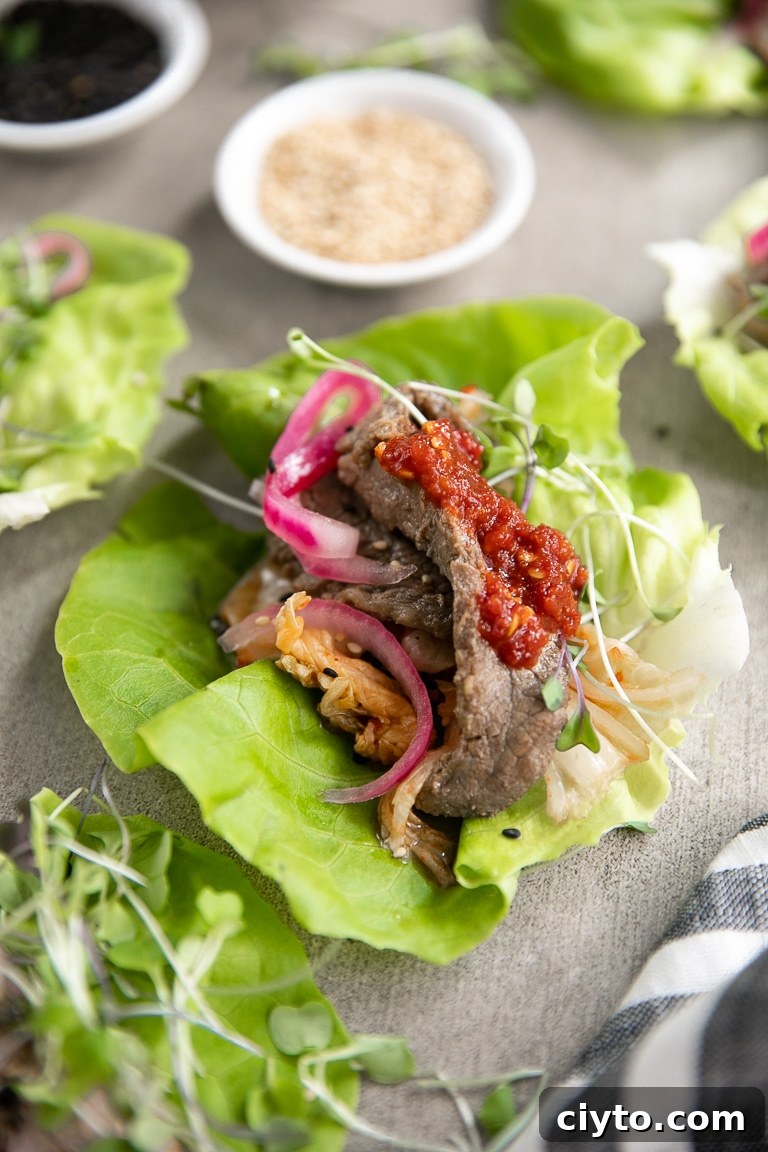 How to Make Korean Bulgogi Beef Lettuce Wraps 2 Lettuce wrap with Bulgogi, kimchi, microgreens, and red onions.