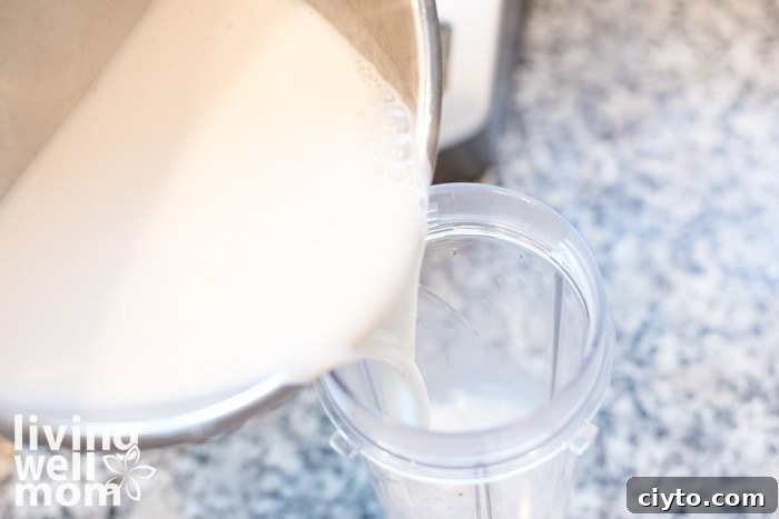 Low-Calorie Matcha Green Tea Latte Recipe for Natural Energy 8 pouring dairy free milk into small blender