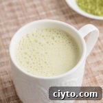 Low-Calorie Matcha Green Tea Latte Recipe for Natural Energy 11 white mug with beige background matcha green tea latte