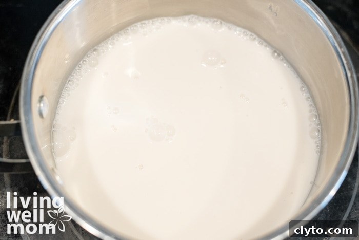 Low-Calorie Matcha Green Tea Latte Recipe for Natural Energy 7 pot of almond milk on the stovetop