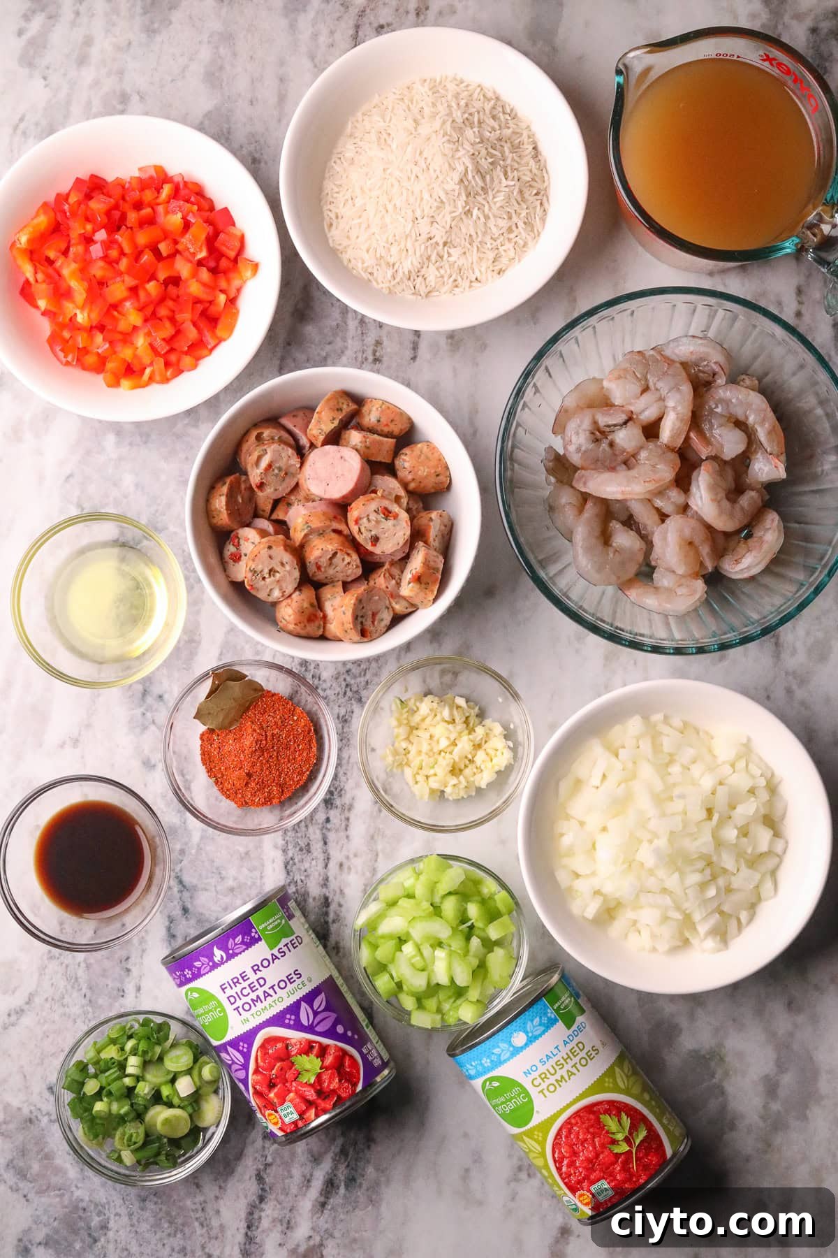One-Pot Shrimp and Sausage Jambalaya Recipe 3 Ingredients for making shrimp and sausage jambalaya arranged in bowls on a table top.