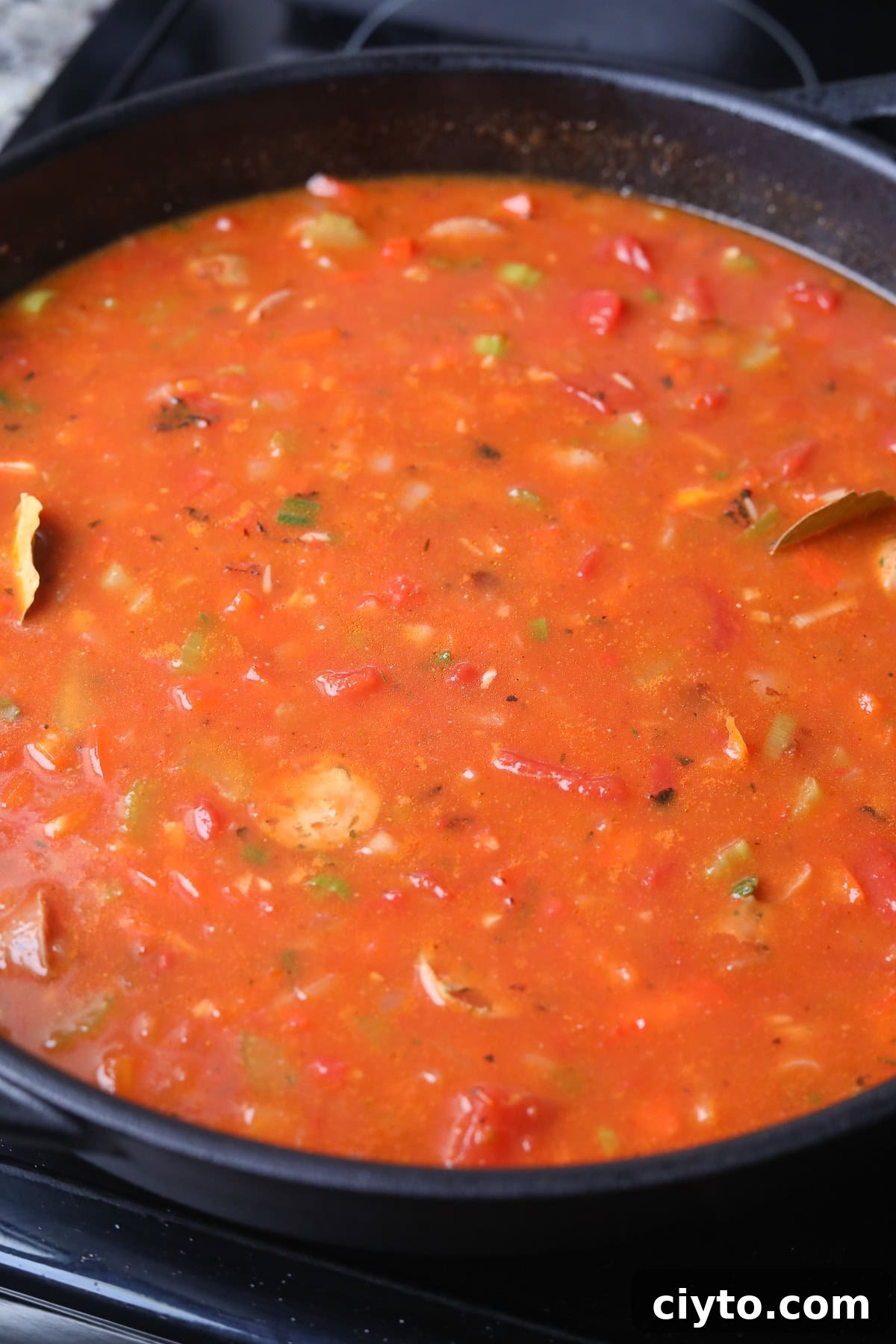One-Pot Shrimp and Sausage Jambalaya Recipe 6 Shrimp and sausage jambalaya with rice simmering on the stove top.