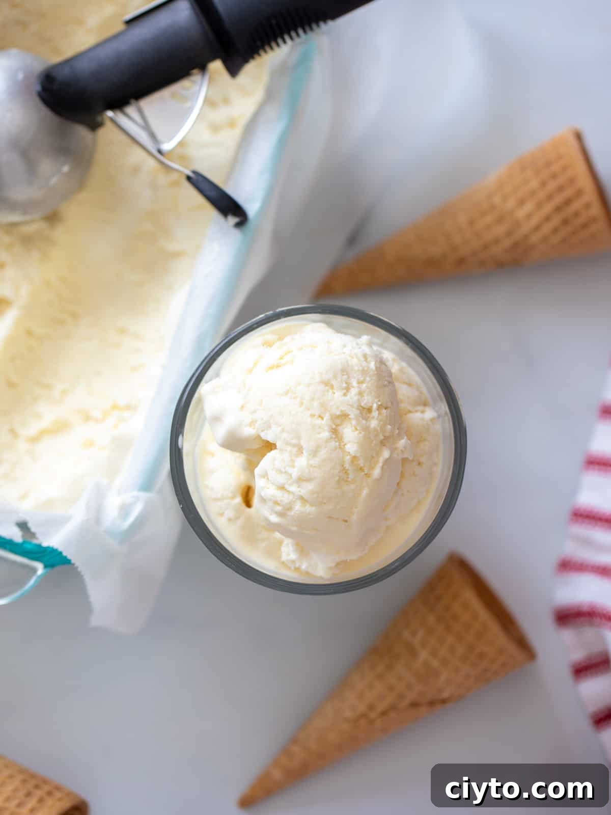 Bowl of ice cream next to loaf pan of no-churn ice cream.