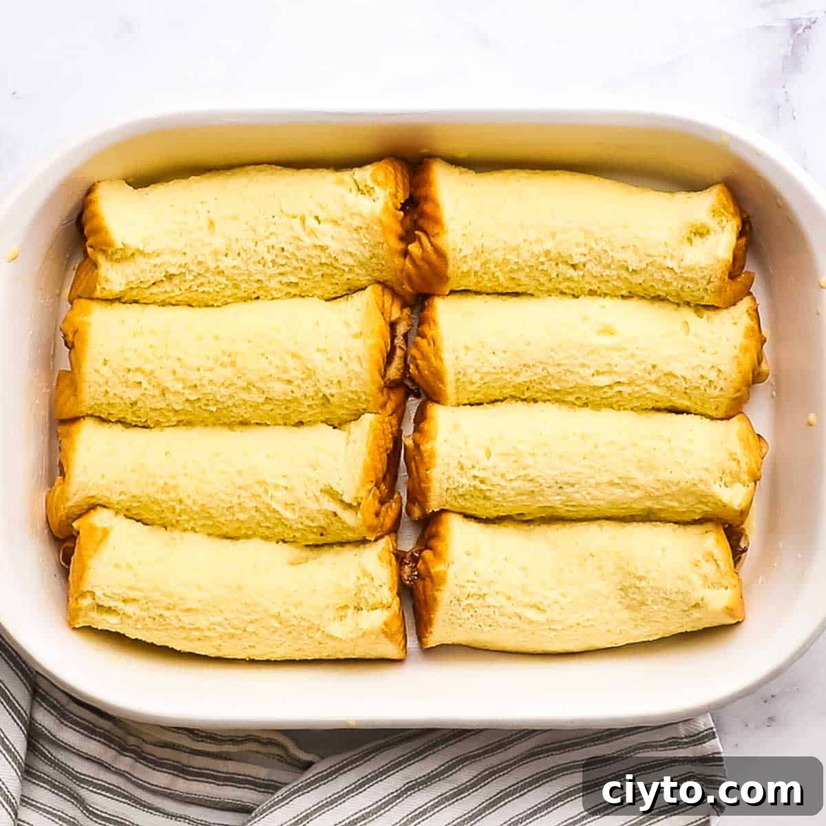 nutella rolls on a baking dish with egg mixture poured on it