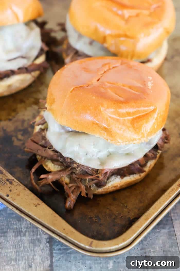 Slow Cooker Shredded Beef Sandwich Recipe 2 Slow Cooker Shredded Beef Sandwiches on a baking sheet